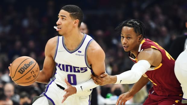 Dec 11, 2021; Cleveland, Ohio, USA; Sacramento Kings guard Tyrese Haliburton (0) controls the ball as Cleveland Cavaliers guard Isaac Okoro (35) defends during the first quarter at Rocket Mortgage FieldHouse. Mandatory Credit: Ken Blaze-USA TODAY Sports